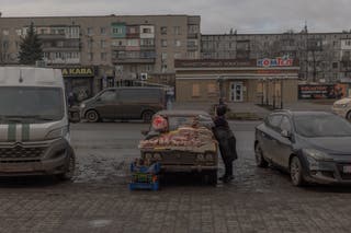 A woman sells meat in a street in Druzhkivka the Donetsk region amid the Russian invasion of Ukraine